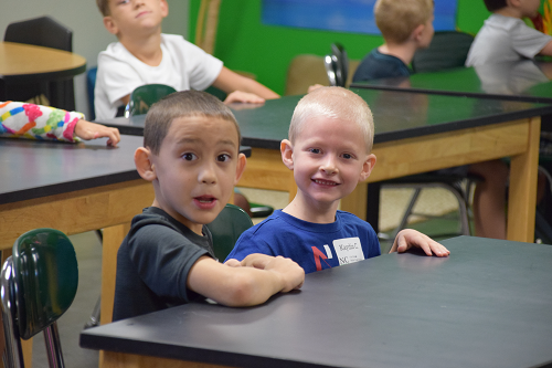 two boys on first day of school sitting at desk